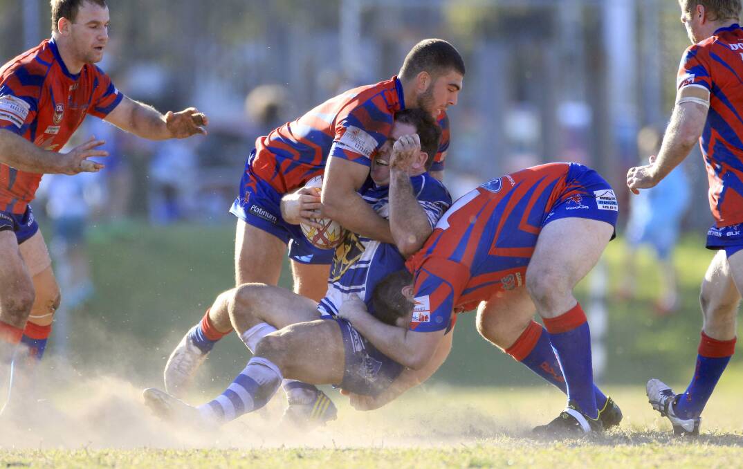 Thirroul's Aaron Beath is crunched in a two-man tackle by Wests at Gibson Park. Picture: ANDY ZAKELI