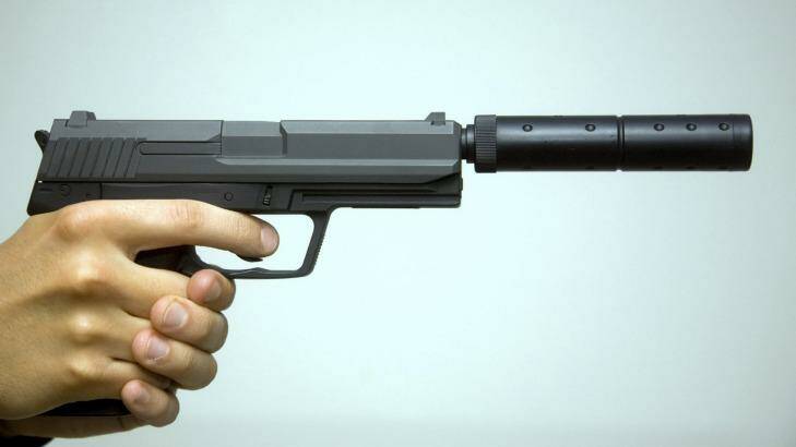 A gun with a silencer attached.