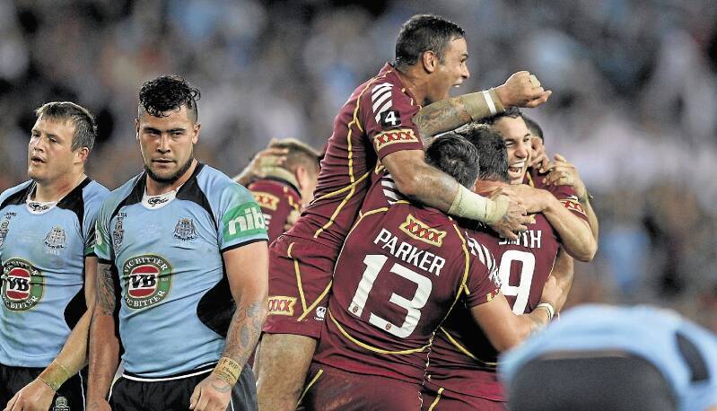 The Maroons celebrate their 12-10 victory over NSW in game three at Homebush last year. Picture: BRENDAN ESPOSITO
