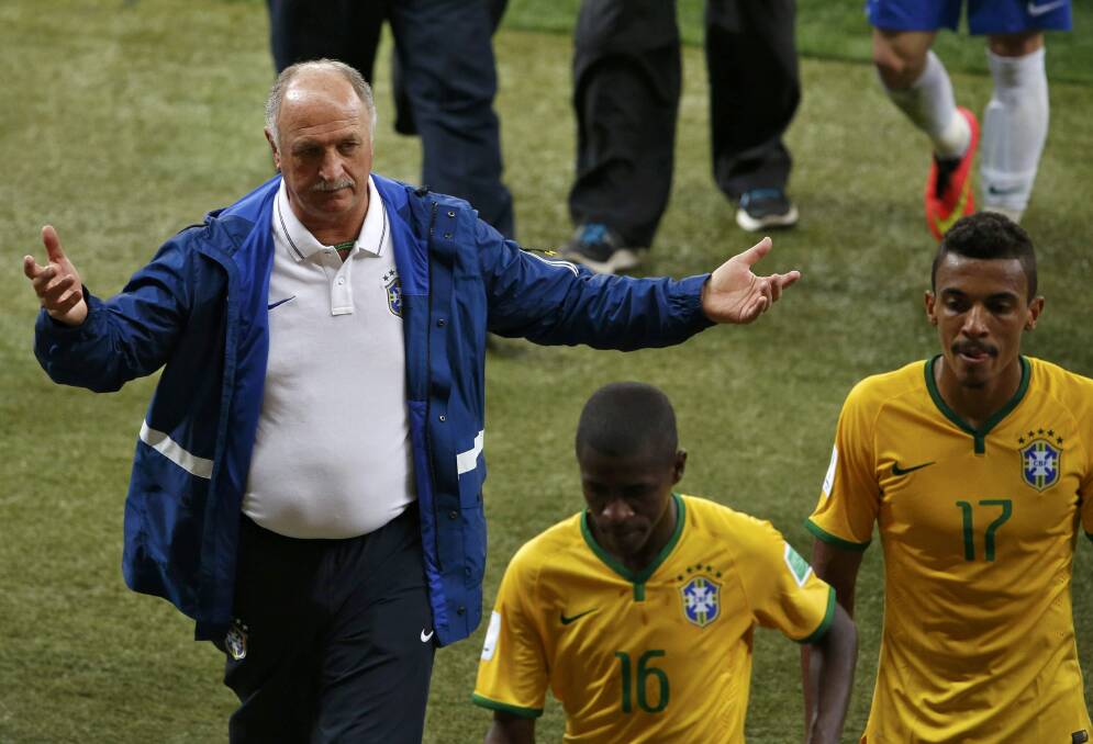 Brazil's coach Luiz Felipe Scolari gestures as Ramires (centre) and Luiz Gustavo file past after their 7-1 loss to Germany. Picture: REUTERS