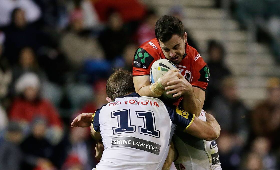 The Dragons' Justin Hunt is sandwiched in a two-man Cowboys tackle on Saturday. Picture: GETTY IMAGES