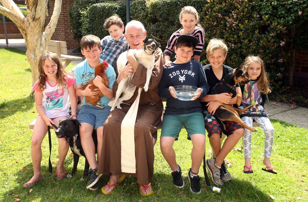 Advertiser. Blessed Animals. L to R. Anna Chamberlain. Samuel Milross-Rose. Rory Milross-Rose. Fr Ken Cafe. Michael Milross-Rose. Elise Milross-Rose. Koen Plat and Amelie Kelly. prepare for the blessing of the Animals at St Michaels Catholic Church in Thirroul. Friday 26 September 2014. Story. Agron Latifi. Photo. Kirk Gilmour