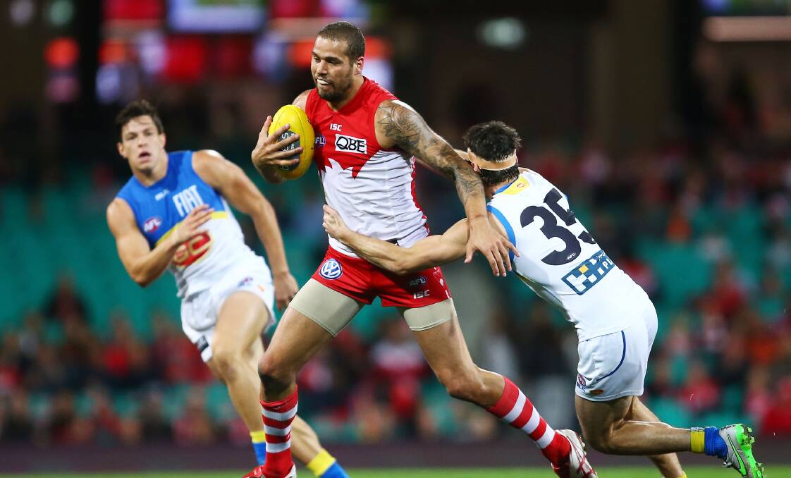 Lance Franklin is tackled by Michel Rischitelli in the Swans' win over Gold Coast. Picture: GETTY IMAGES