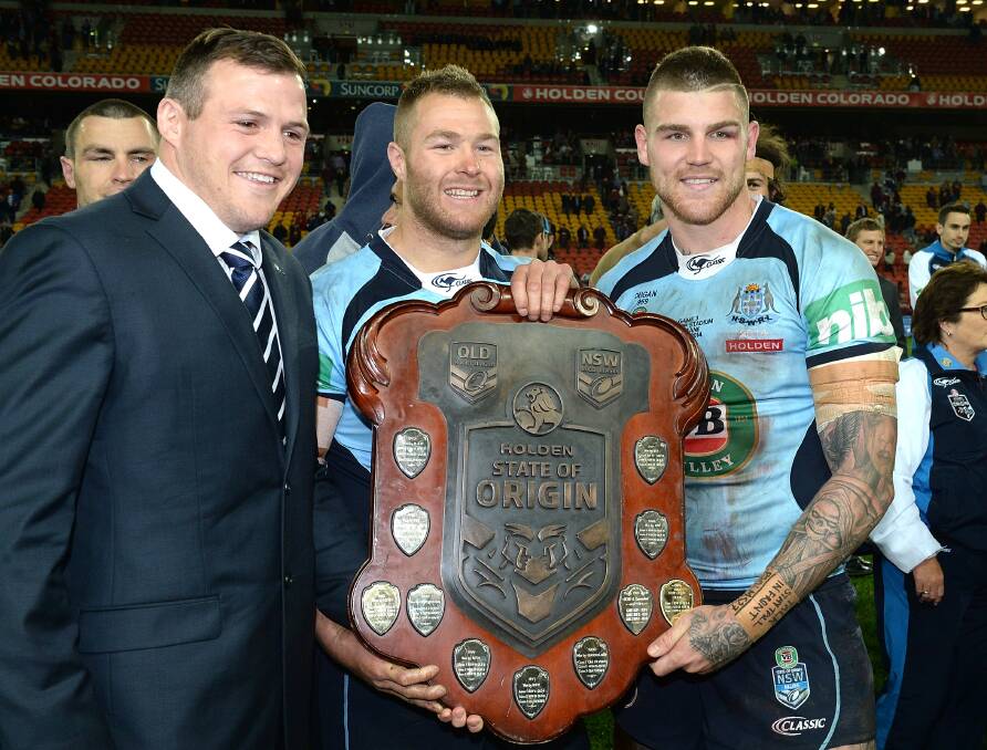 Brett Morris, Trent Merrin and Josh Dugan with the Origin shield after Origin III on Wednesday. Picture: GETTY IMAGES