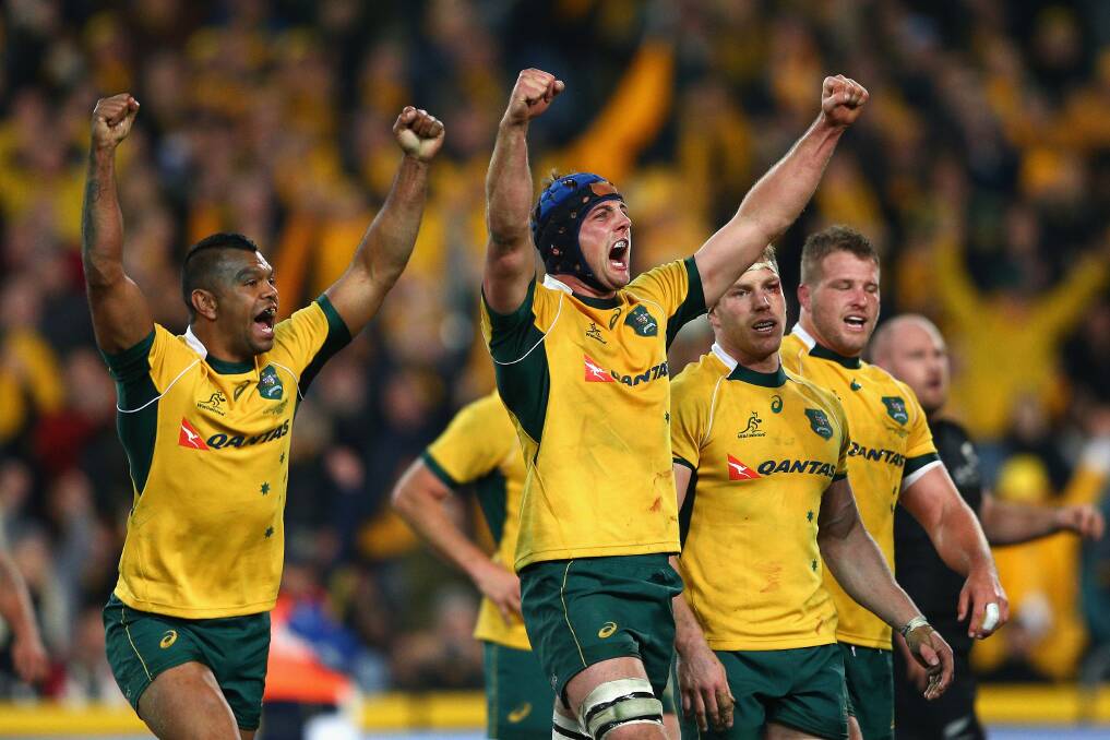 Wallabies lock Dean Mumm, mid-picture, celebrates Australia's win over the All Blacks on Saturday. Picture: GETTY IMAGES