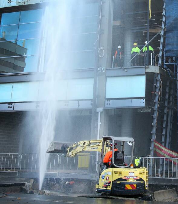 Water gushes from the main pipe on Keira Street.