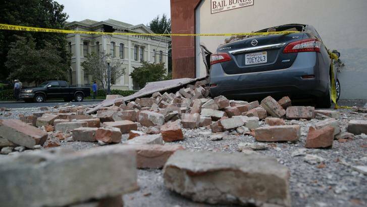 Bricks and fallen rubble cover a car following Sunday's earthquake in California. Photo: Eric Risberg
