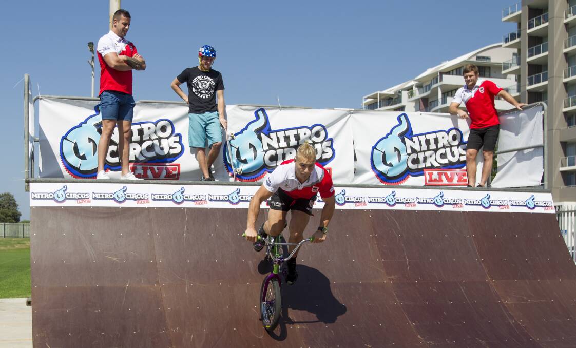 Dragons player Jack de Belin tests the Nitro Circus BMX mini-ramp at WIN Stadium on Wednesday as teammates look on. Picture: CHRISTOPHER CHAN