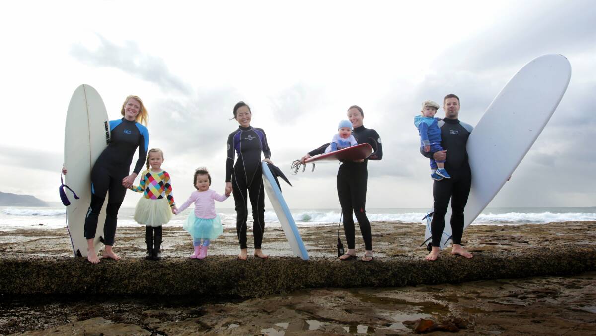 Playgroup members Elin Bjornsdottir, left, with daughter Daney, Nina with her mum Mimi Lennon, baby Dylan and mum Elyse Comerford, Svanur Danielsson with his son Stormur at Bellambi Beach. Picture: SYLVIA LIBER