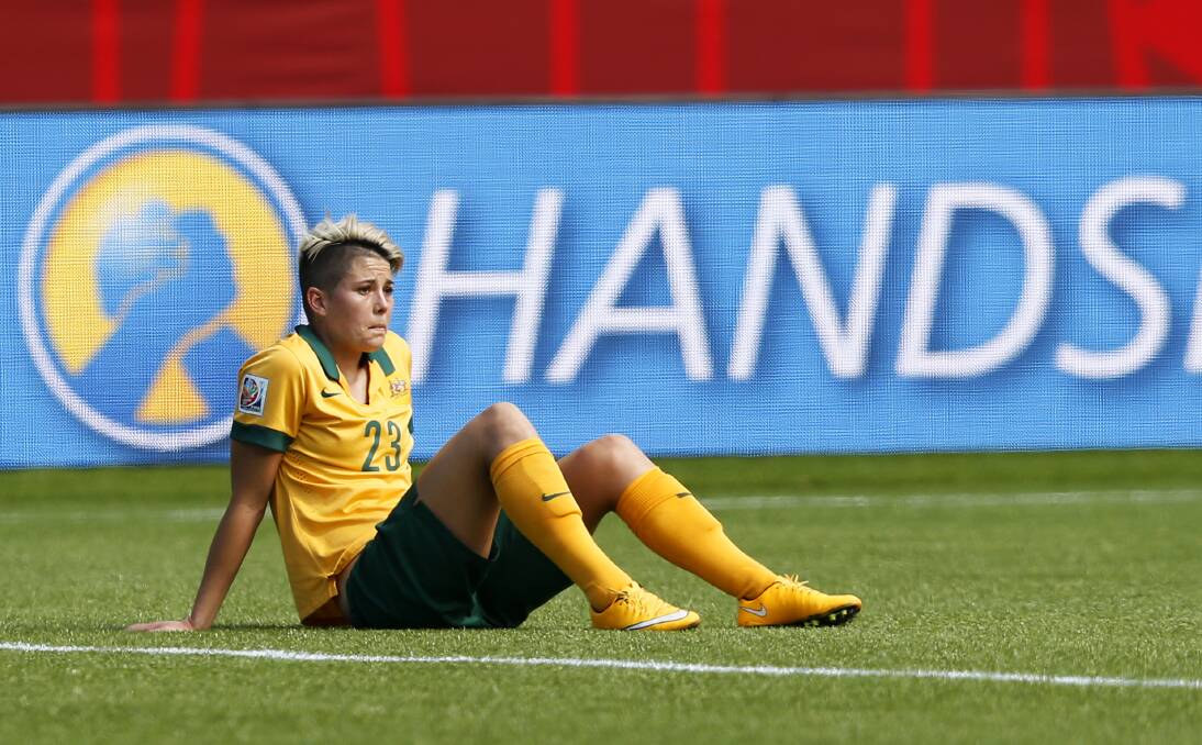 Michelle Heyman sits on the turf devastated after Australia's 1-0 loss to previous Asian and World Cup winners Japan. Picture: GETTY IMAGES
