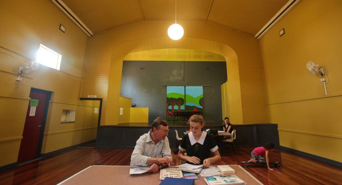 Volunteer Jeremy Staines helps Charlotte Power with her maths homework at The Smith Family's after-school homework program.Picture: ADAM McLEAN