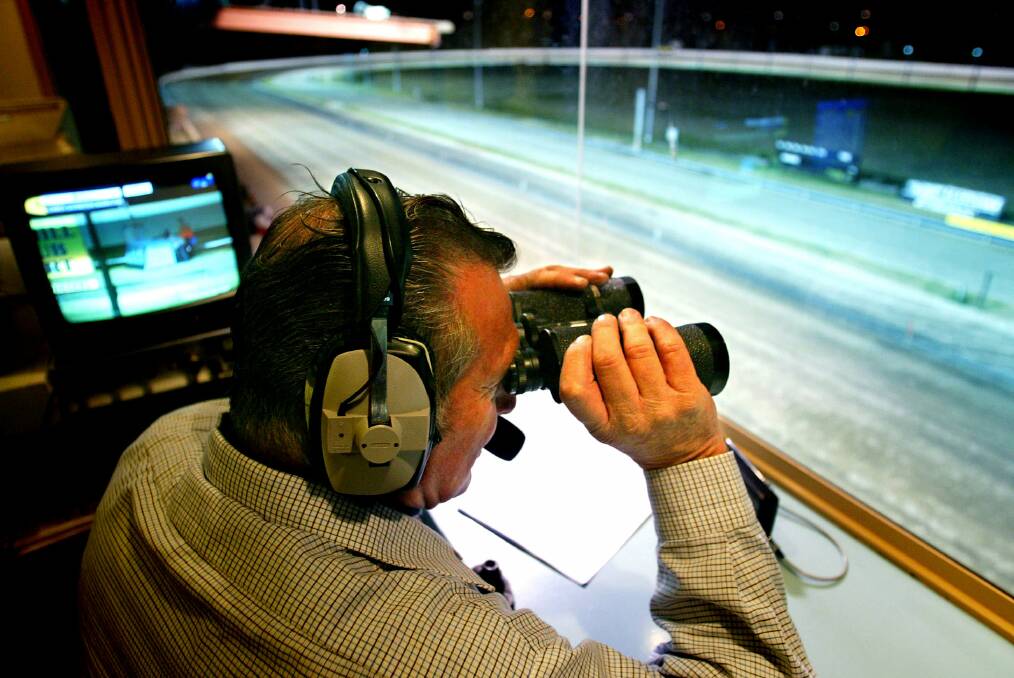 Paul Ambrosoli on the job at Bulli in 2004. The Hall of Fame race caller will call his last race at Wentworth Park on Saturday. Picture: PAUL JONES