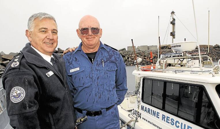 Marine Rescue NSW Commissioner Stacey Tannos, left, congratulates Graeme McCrudden. Picture: GREG TOTMAN
