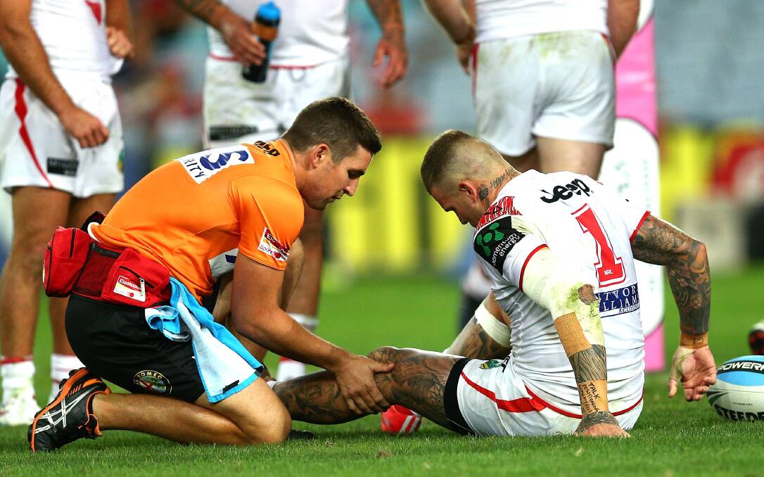 Josh Dugan is attended to after injuring his left knee on Saturday night. Picture: GETTY IMAGES