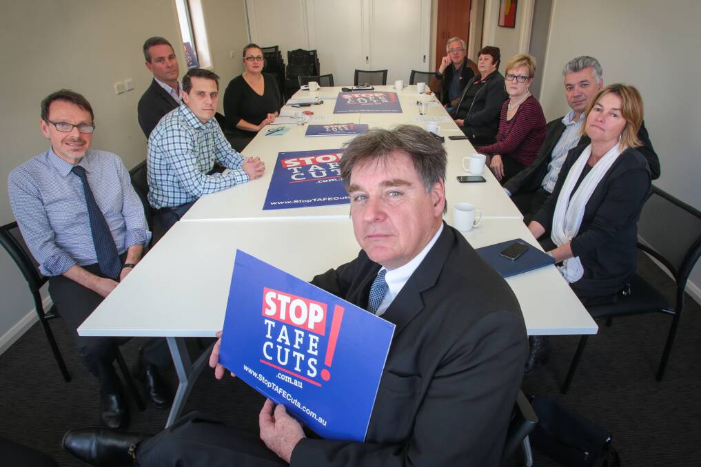 Maurie Mulheron (front) with others from political, union and teaching sectors during a meeting in Wollongong to talk about the Stop TAFE cuts campaign. Picture: ADAM McLEAN