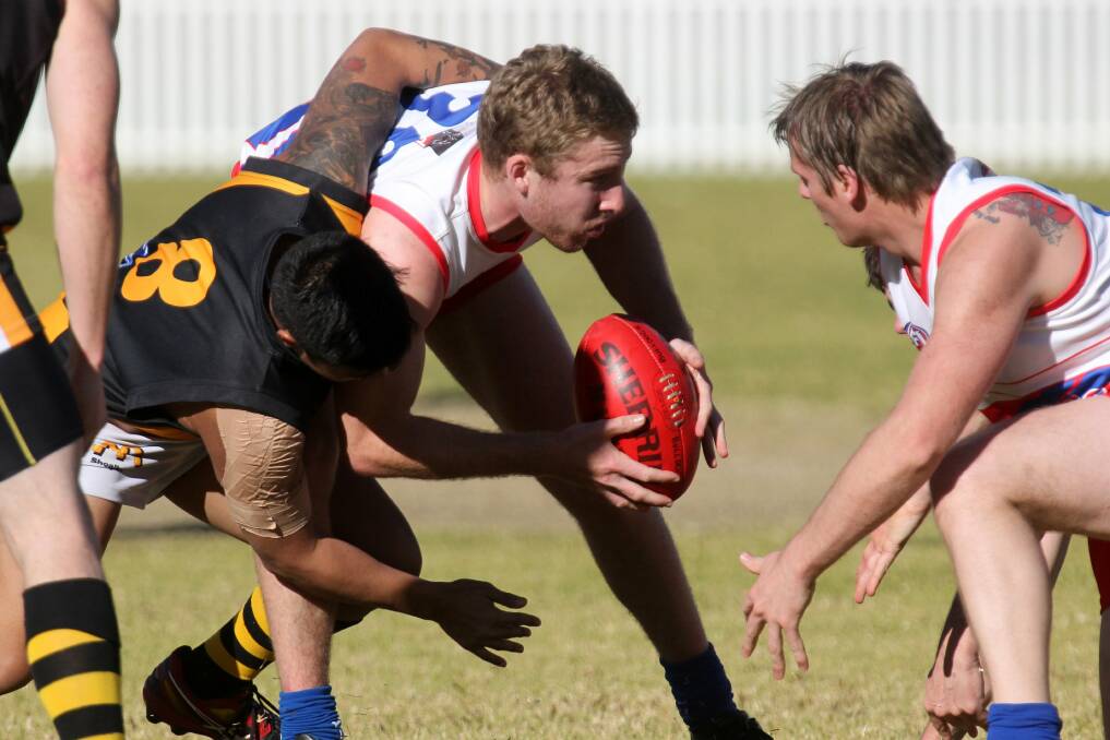 Wollongong's Jack Wells (centre) and Aaron Guy in the thick of the action on Saturday. Picture: GREG TOTMAN. 
