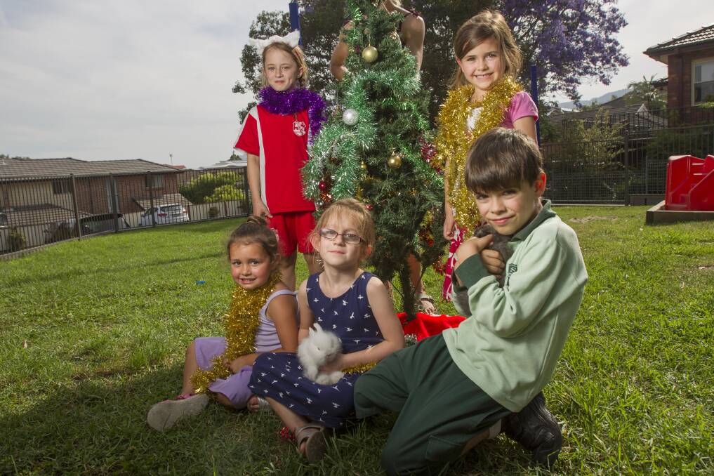 Poppy Esdale, Alleira Walker, Victoria Darby, Miriam and Sam Olmos will take part in both Corrimal Anglican Church's Outdoor Christmas Carols on December 7 and Corrimal Public School's annual Carols by Candlelight on December 5. Picture: CHRISTOPHER CHAN