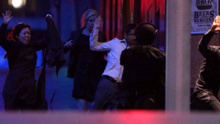 Hostages flee after police raided the Lindt cafe. Photo: Andrew Meares