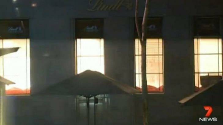 Awful end: The Lindt cafe lights up as police storm the building. Photo: Channel Seven