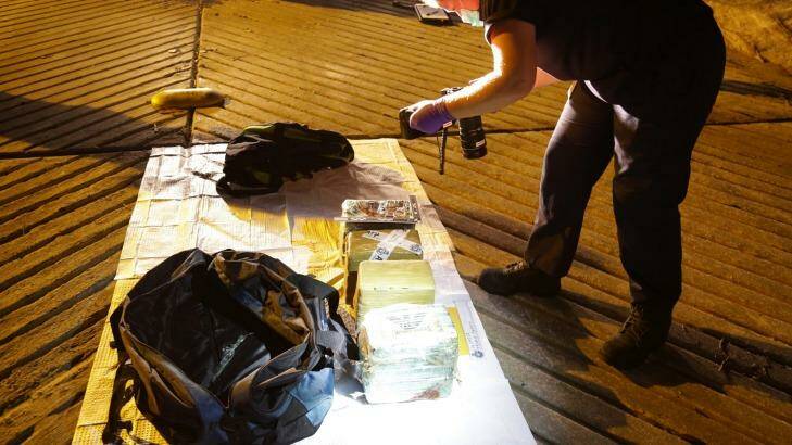 Officers examine drugs seized from a dinghy as it moored in Parsley Bay on the NSW Central Coast. Photo: NSW Police Media