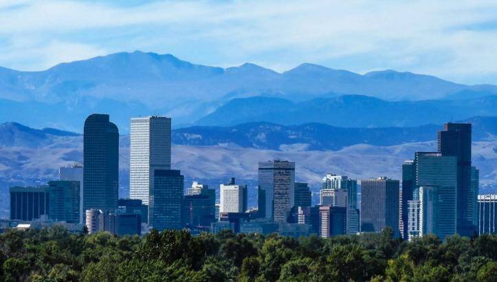 The Denver city skyline, downtown against the backdrop of the Rocky Mountains.