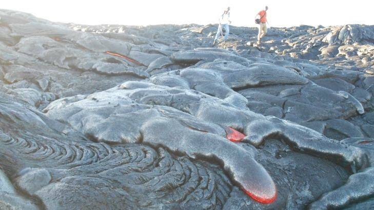 People walking among flowing lava. Photo: Maria_Ermolova
