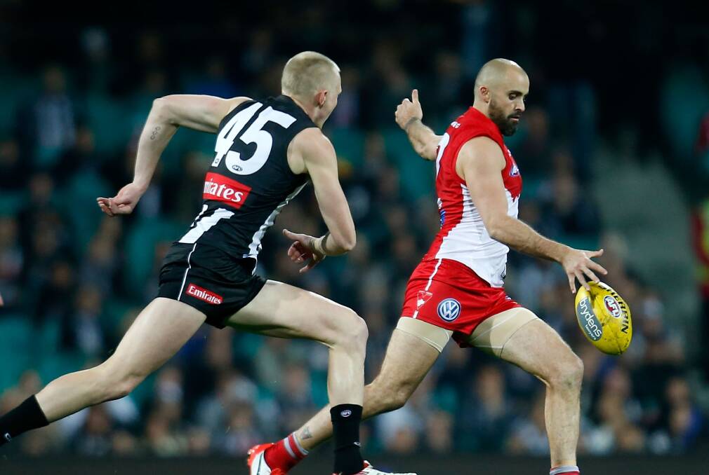 Swans' Rhyce Shaw clears the defensive line with Magpies' Jack Frost in pursuit. Picture: GETTY IMAGES