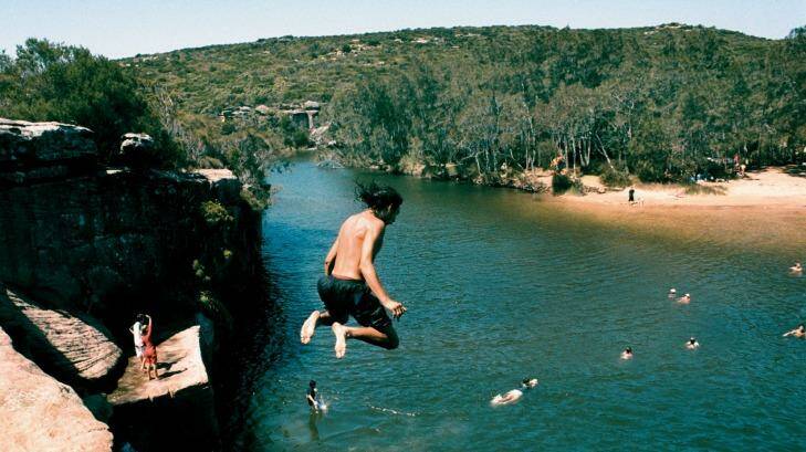 Kids jumping off rocks into Wattamolla lagoon. Photo: Tamara Dean