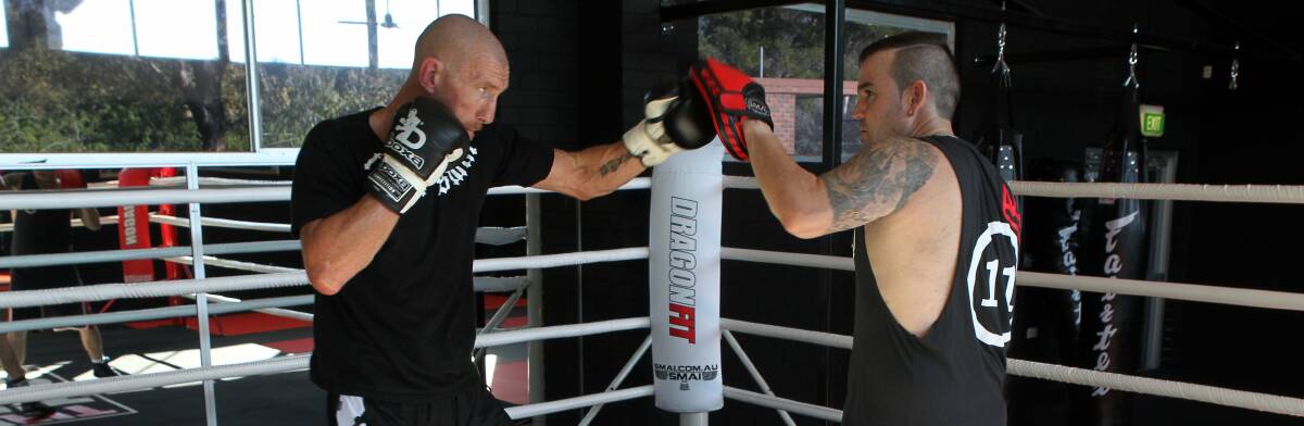 Adrian Campbell working out with coach Brad Gallagher ahead of next week's clash. Picture: GREG TOTMAN