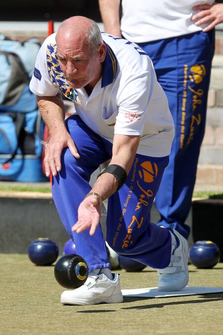 Dapto's Ron Draper plays his bowl during the annual Dapto Flyaway Triples. Draper's team finished third with four wins. Picture: GREG TOTMAN