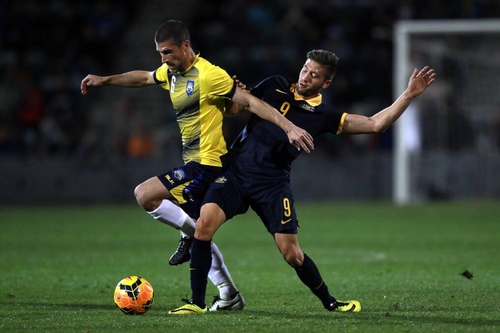 Nick Montgomery wins the ball from Young Socceroos player Brandon Borrello while playing for the A-League All-Stars at WIN Stadium earlier this month. Picture: SYLVIA LIBER