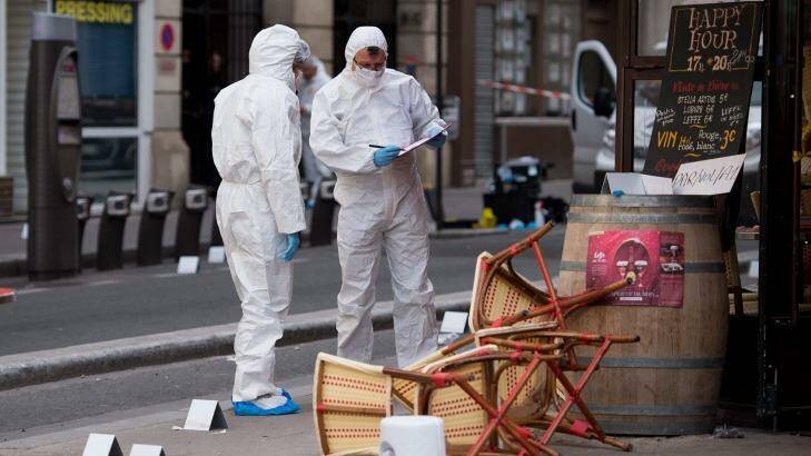 Police forensic experts work on the scene of one the shootings that took place in Paris at the Cafe Comptoir Voltaire. Photo: EPA/Marius Becker