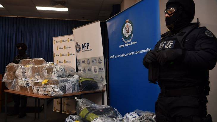 AFP officers stand guard over some of the cocaine seized during the Christmas Day drug bust. Photo: Kate Geraghty