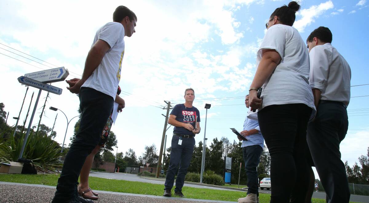 Pressure: The Teachers Federation's TAFE organiser, Rob Long, talks with candidates and campaigners outside the TAFE complex in Foleys Lane, North Wollongong, on Wednesday. Picture: KIRK GILMOUR