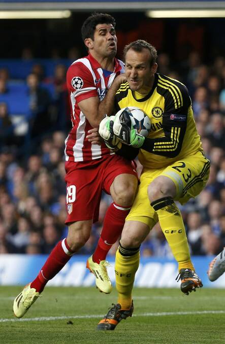 Safe: Mark Schwarzer is challenged by Atletico Madrid's Diego Costa on Wednesday. Picture: REUTERS