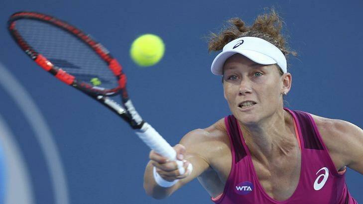 Full stretch: Sam Stosur scrambles to keep the ball in play against Monica Puig. Photo: Rick Rycroft