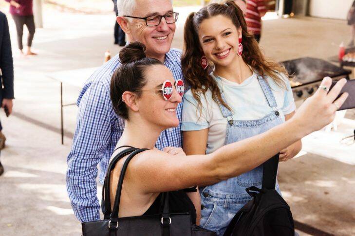 Bennelong by-election, 2017. Photograph shows Prime Minister Malcolm Turnbull paused for a phogto with two stop adani protestors, whilst campaigning with Liberal candidate John Alexander at Gladesville Public School polling booth. Saturday 16th December 2017. Photograph by James Brickwood. SMH NEWS 171216 fedpol