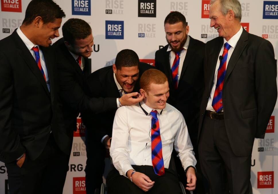 Alex McKinnon has his Newcastle teammates on hand before he addresses the media at ANZ Stadium on Monday. Picture: JONATHAN CARROLL