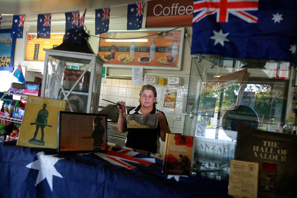 Complete takeover: Debbie Crouch at her shop with some of the Anzac items. Picture: SYLVIA LIBER