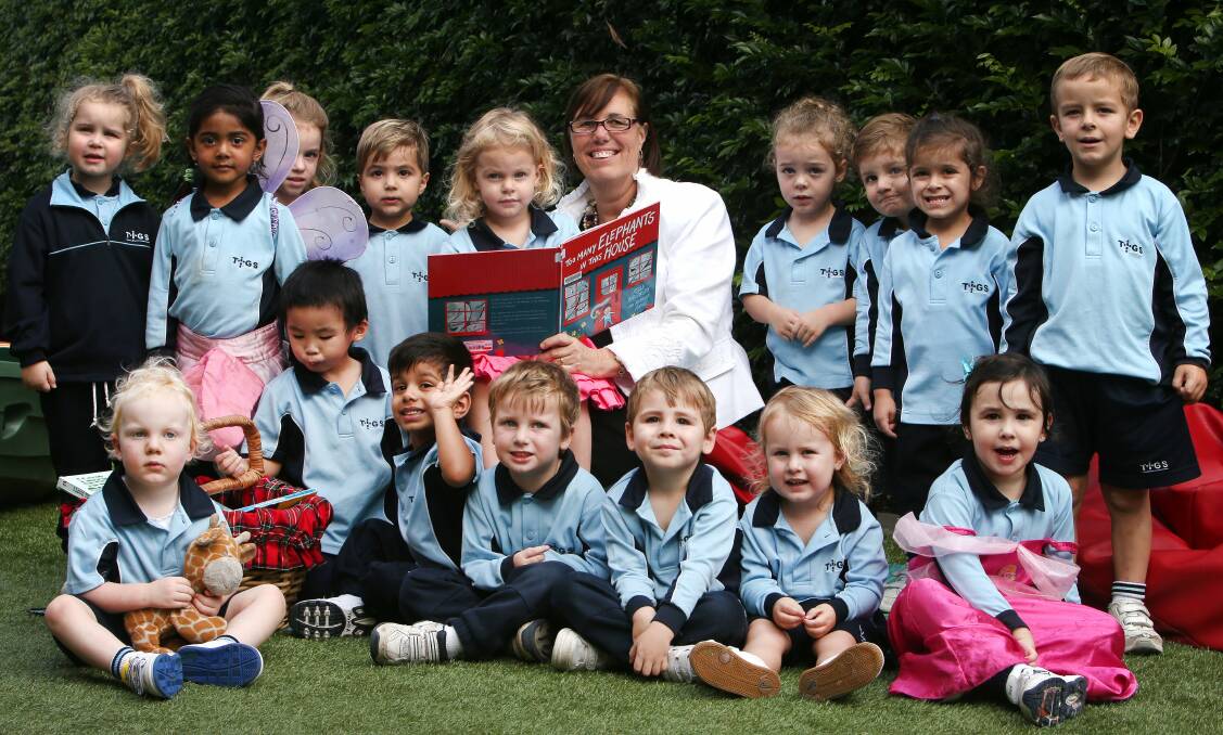 Rapt: The Illawarra Grammar School librarian Petra Pollum joined in National Simultaneous Storytime, a campaign to promote literacy, on Wednesday when she read to a class preschoolers. Picture: KIRK GILMOUR