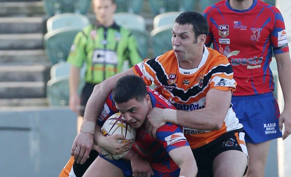 Tiger Kel Tate downs  a Wests attacker in a game Helensburgh turned around in the second half at WIN Stadium to run out 22-16 winners.  ROBERT PEET
