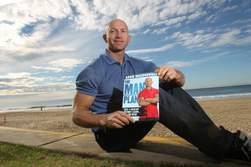 Former Newcastle Knight Adam MacDougall with his Man Plan book on Tuesday. Picture: GREG TOTMAN