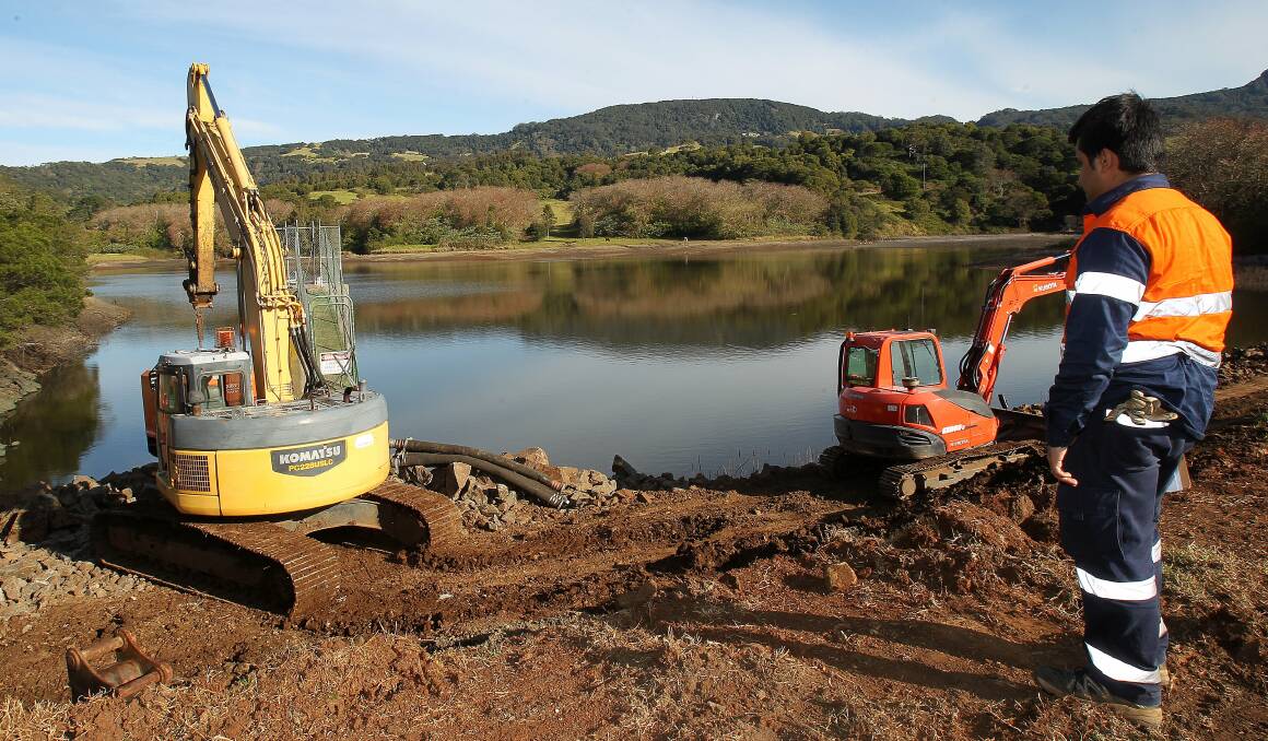 Costly obligation: Contractors work at Jerrara Dam, which is about to be decommissioned by Kiama Council.Picture: GREG TOTMAN