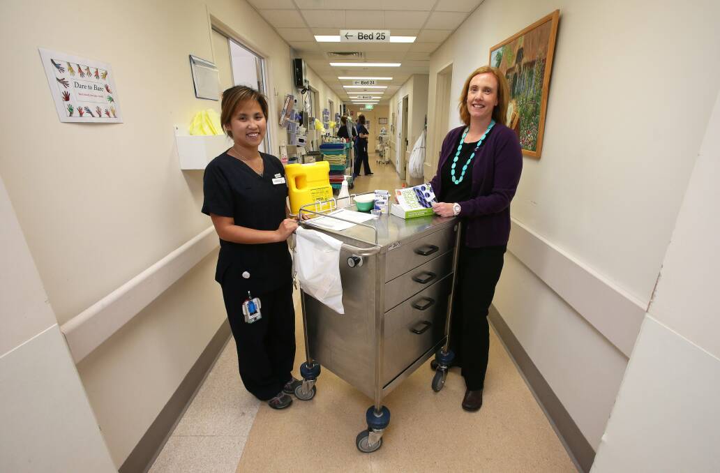 Wollongong Hospital dietitian Kelly Lambert liaises with nurses, such as registered nurse Christine Mantilla, to ensure patients' nutritional needs are met. Picture: KIRK GILMOUR