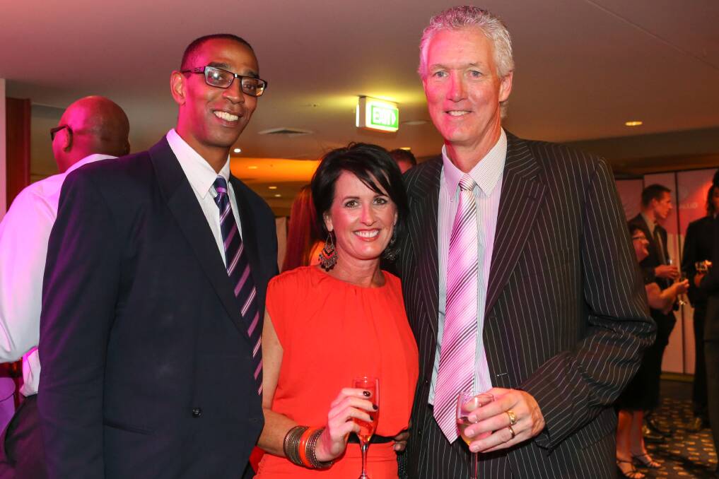 Eric Cooks (left), Josie Cooks and Chuck Harmison at the Hawks’ presentation night in 2013.  Picture: ADAM McLEAN