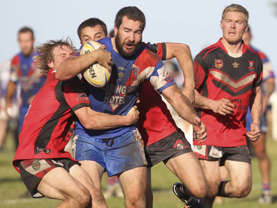 Charge: Gerringong Lions five-eighth Patrick Cronin struggles to get away from the Kiama Knights defence at Kiama Showground. Picture: KIAMA PICTURE CO