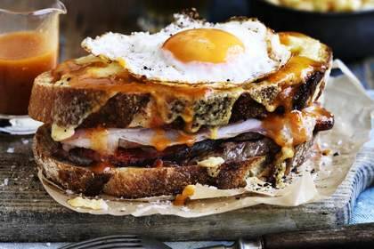Adam Liaw's huge meat-filled toasted sandwich monster is topped with egg and cheese and smothered in a beer-based sauce. Photo: William Meppem