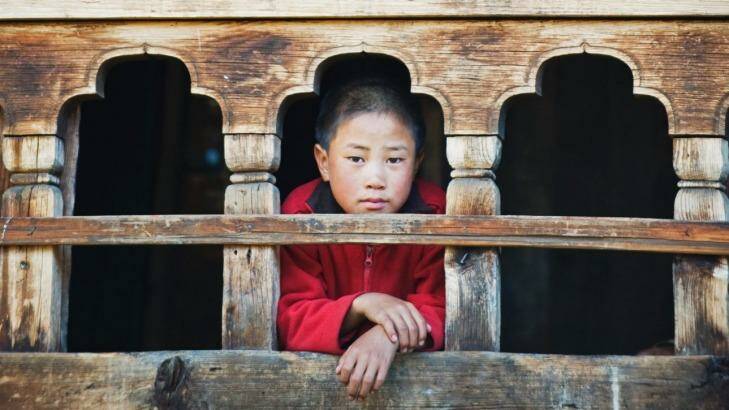 A monk at the window of the Gangtey Gompa Monastery. Photo: Christian Kober