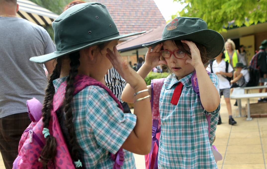 Year 1 students Ayla Jego-Trunk and Sienna Flores unwind a game after teir first day back at St Brigid's Cathloic School, Gwynneville. Picture: ANDY ZAKELI