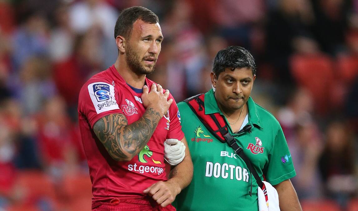 Quade Cooper walks off with a shoulder injury against the Melbourne Rebels. Picture: GETTY IMAGES
